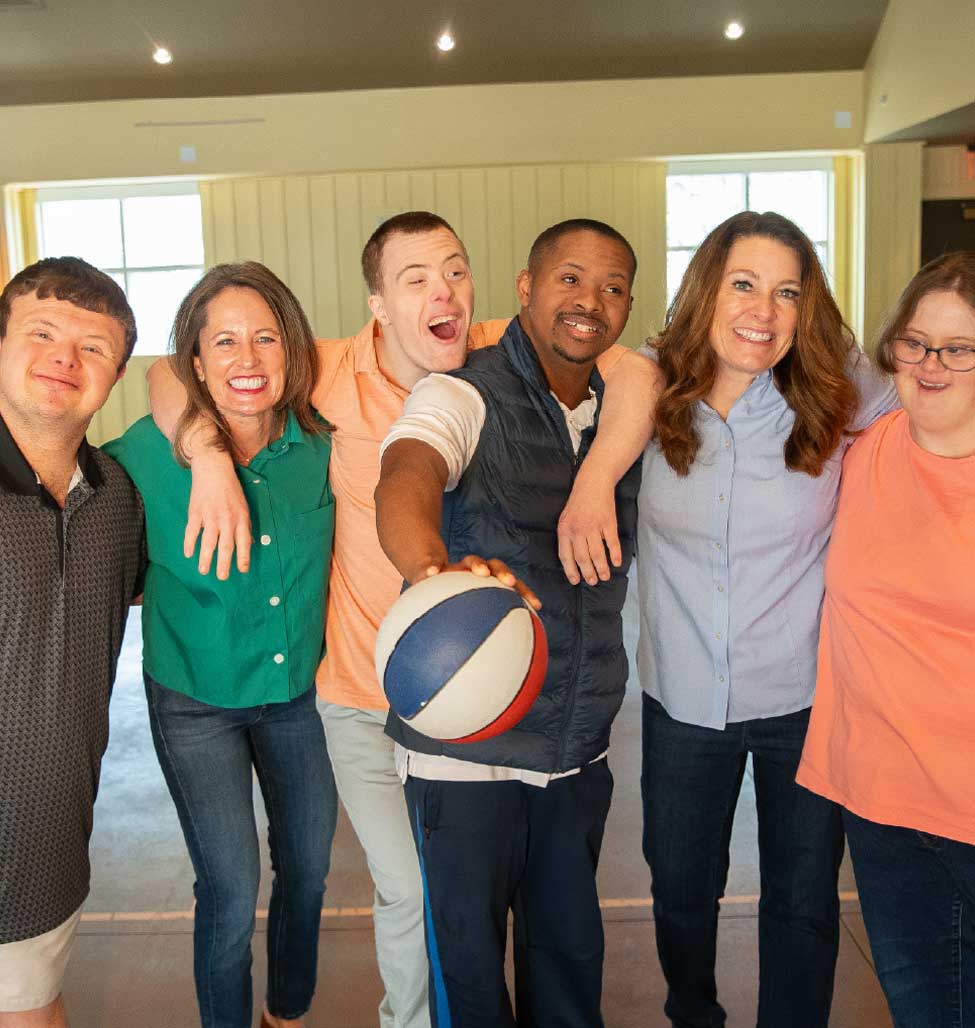 Group of volunteers and Wonderfully Made participants smiling